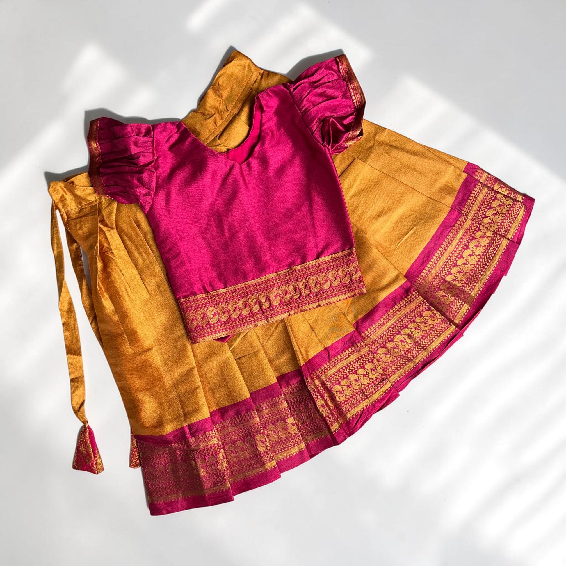 Pink blouse with gold skirt on a white background